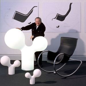 Designer Eero Aarnio with his Double Bubble lamps and Keinu chair